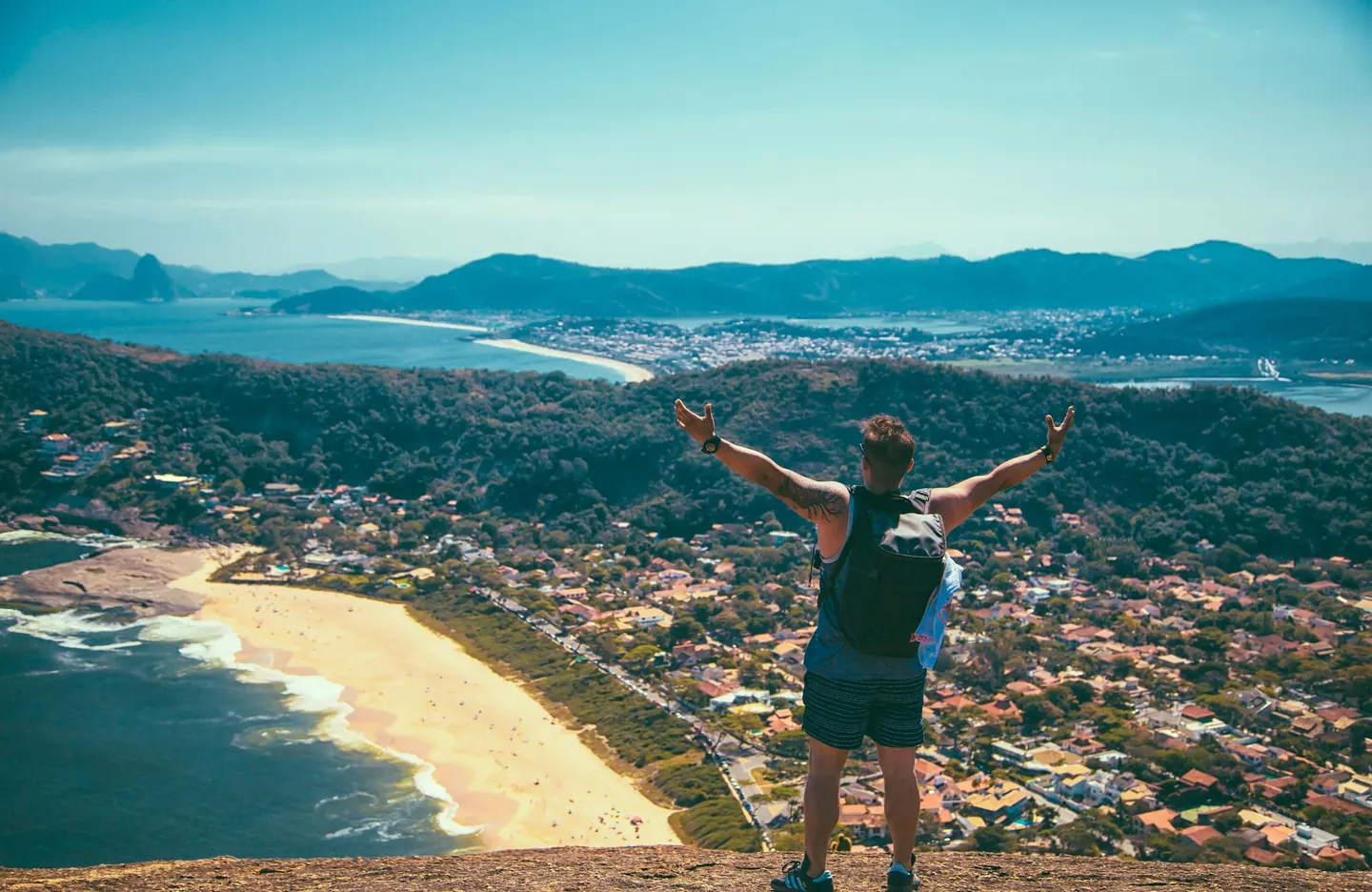 Traveler standing by the sea with local village